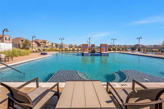 a swimming pool with outdoor seating and yard