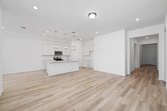a view of kitchen with granite countertop cabinets and refrigerator