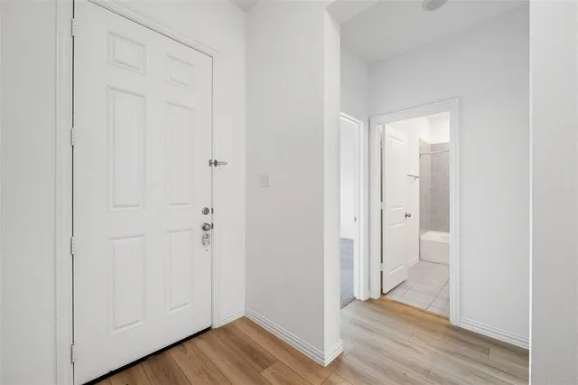 a view of a hallway with wooden floor