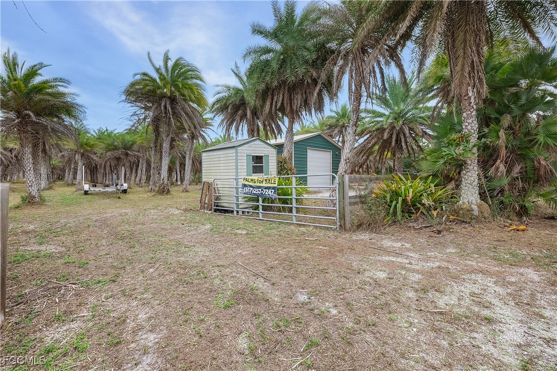 15890 Quail Trail Bokeelia, FL 33922 - Photo 8 of 18 a front view of house with yard and trees