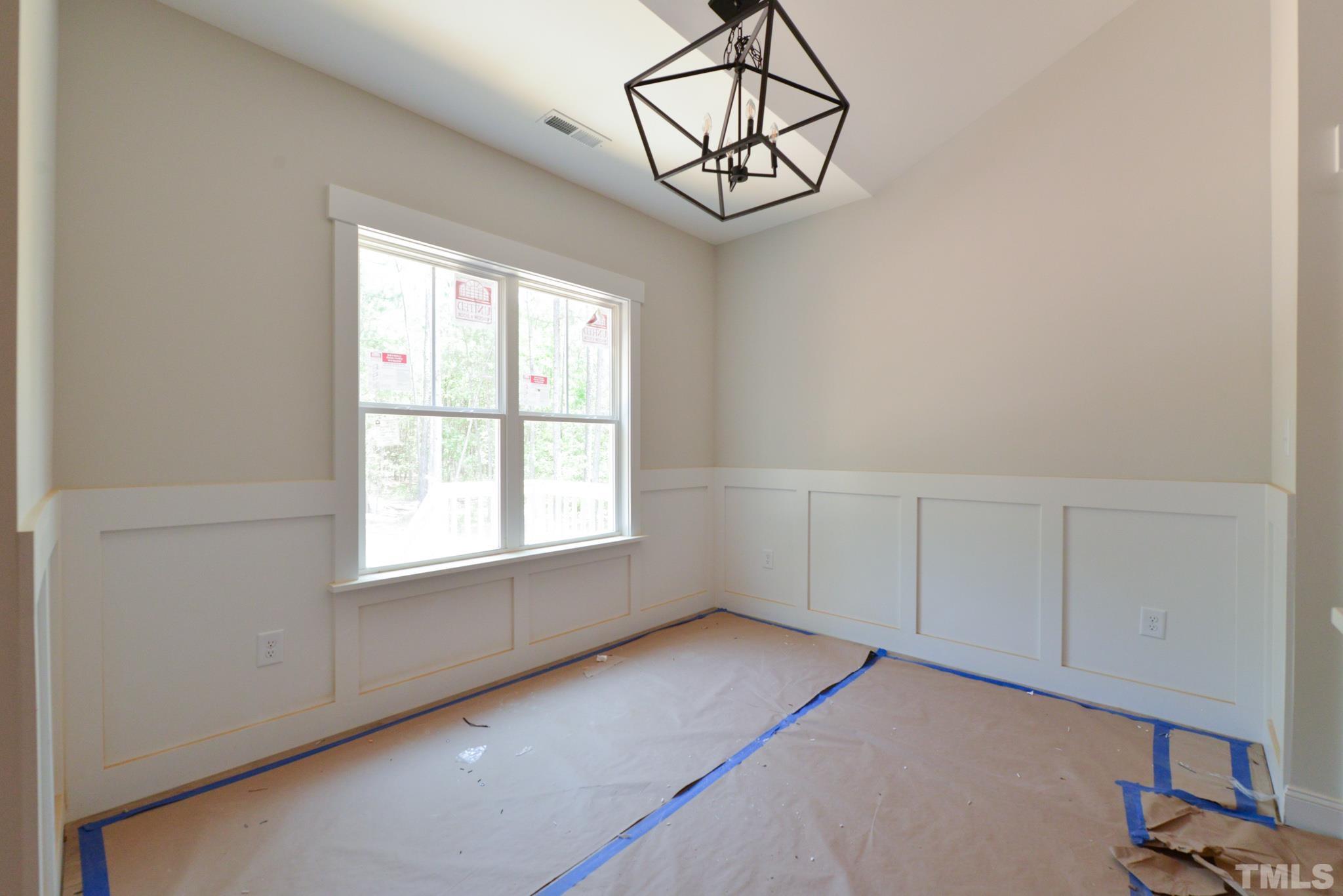 968 Barnes Road Middlesex, NC 27557 - Photo 8 of 31 an empty room with chandelier fan and windows