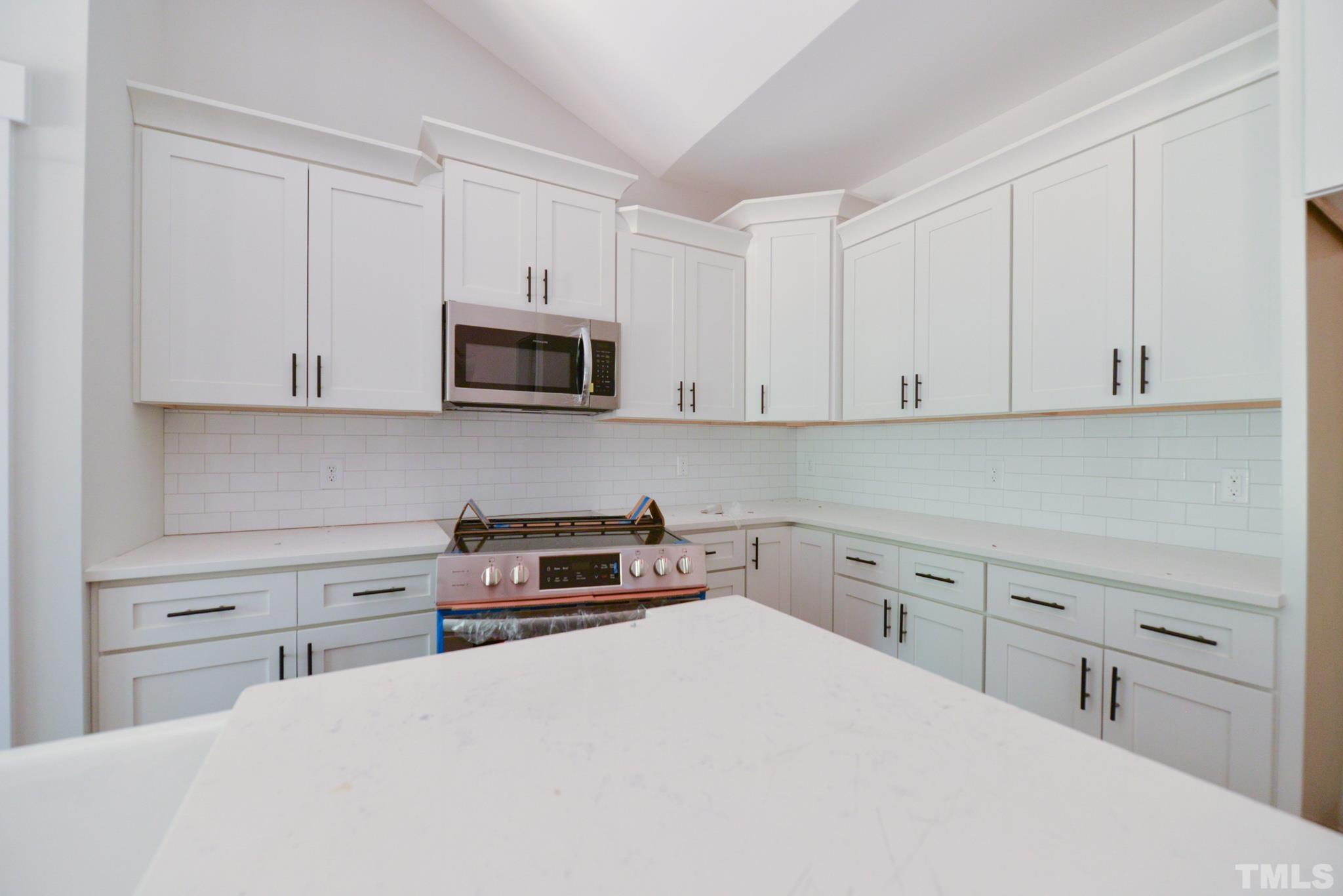 968 Barnes Road Middlesex, NC 27557 - Photo 10 of 31 a kitchen with white cabinets and stainless steel appliances