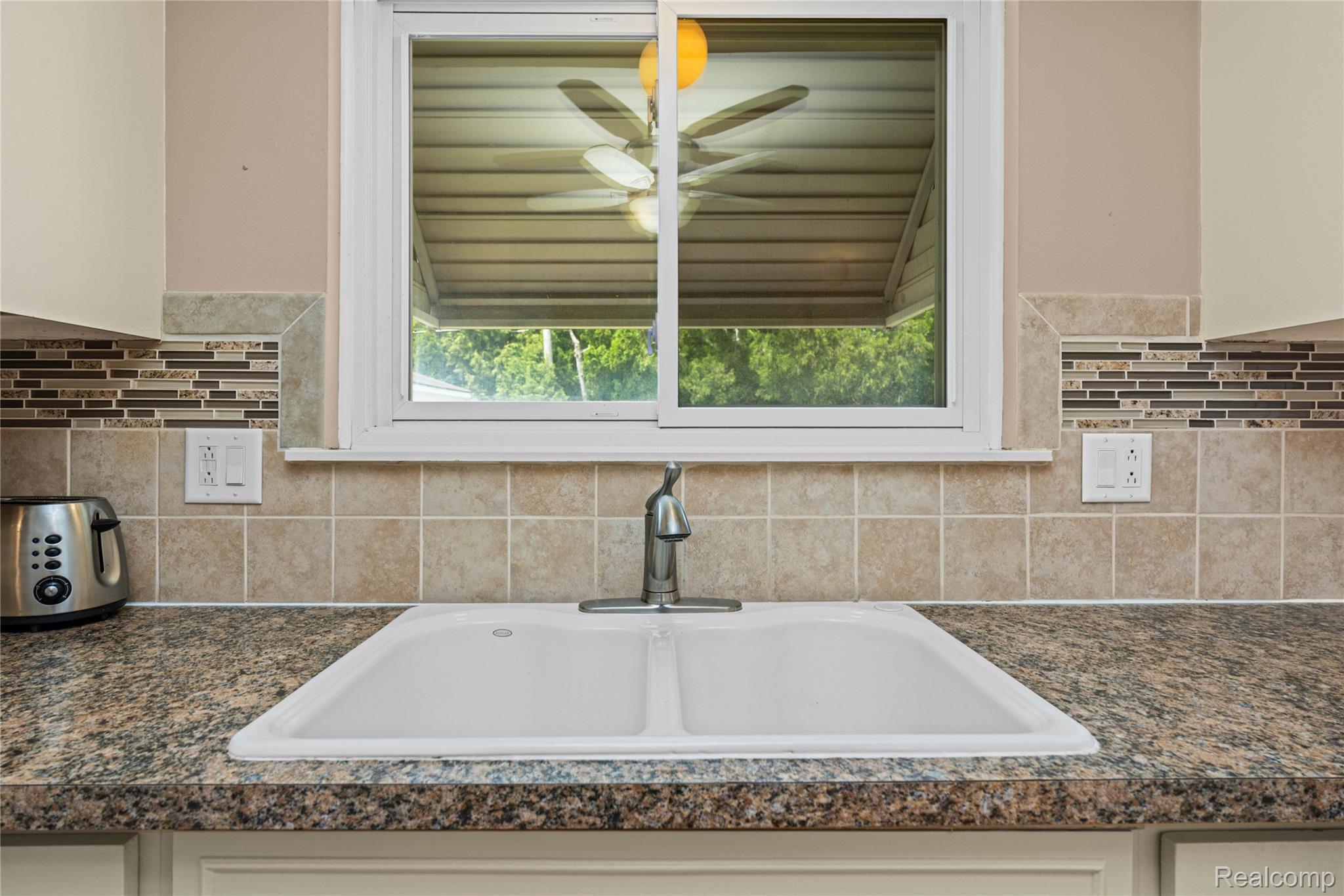 14743 Newburgh Road Livonia, MI 48154 - Photo 14 of 48 Dual-basin sink with a chrome faucet, set into a speckled countertop