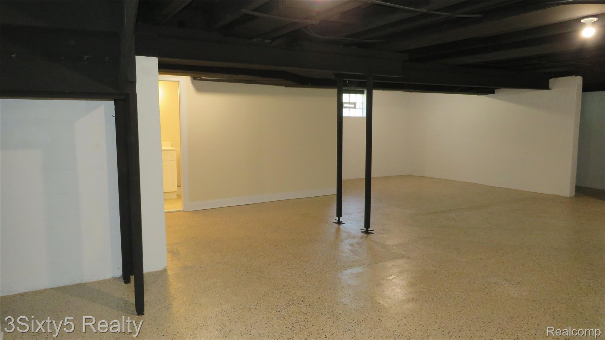 16558 Haggerty Road Belleville, MI 48111 - Photo 28 of 40 Spacious lower-level area featuring light-colored flooring, painted white walls, and a dark-painted ceiling