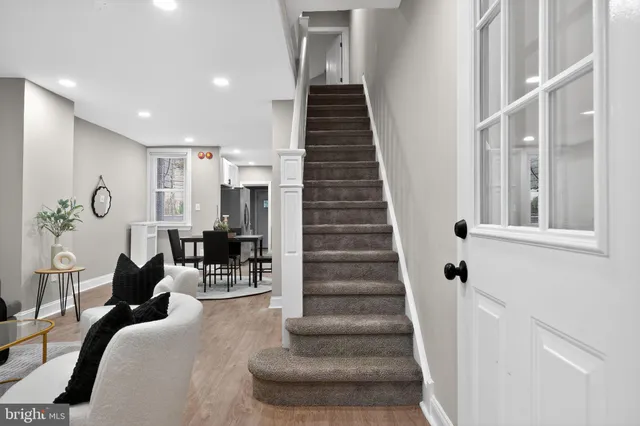 a living room with furniture and a stairs