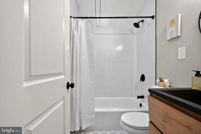 a bathroom with a bathtub a sink a toilet and a shower