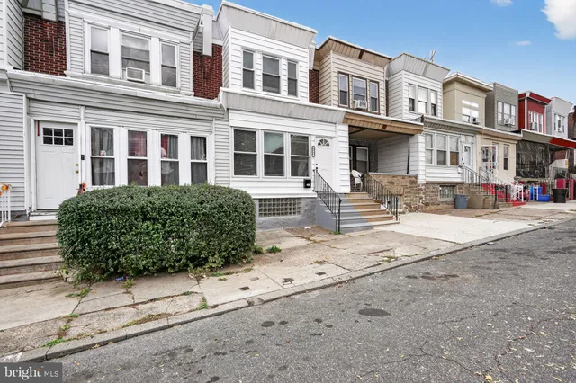 a front view of a building with a garden