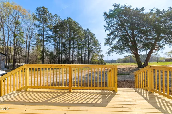 a view of balcony with wooden floor and fence