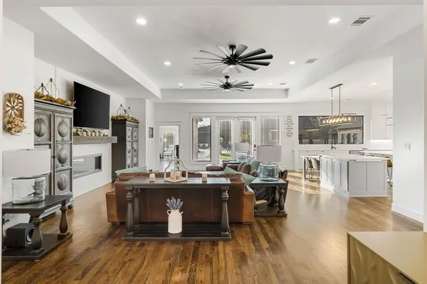 a view of a dining room with furniture a rug and wooden floor