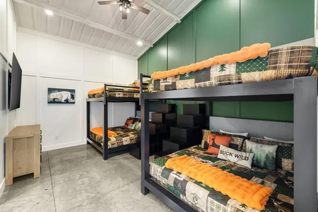 a kitchen with stainless steel appliances kitchen island granite countertop a sink and a refrigerator