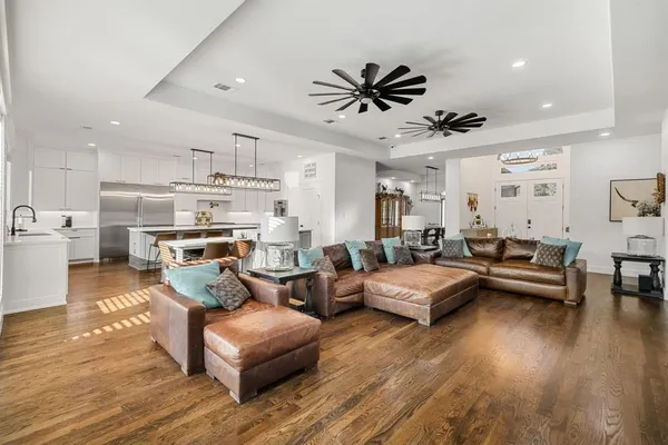 a living room with furniture and a wooden floor