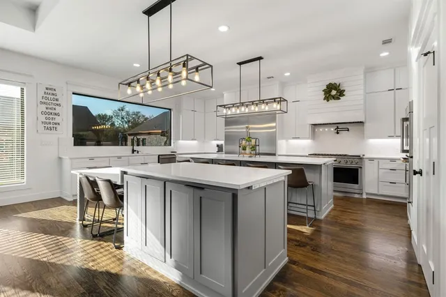 a kitchen with stainless steel appliances granite countertop a stove and cabinets