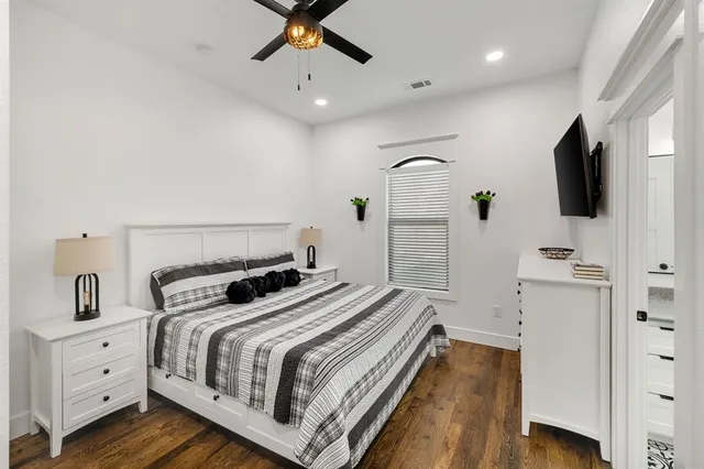 a kitchen with a stove and a flat screen tv