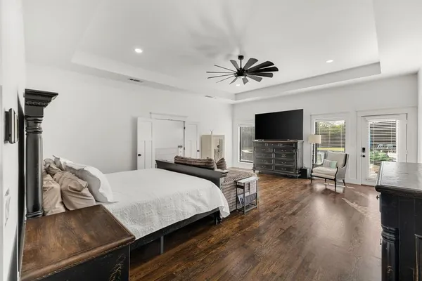 a bathroom with a granite countertop sink toilet mirror and shower