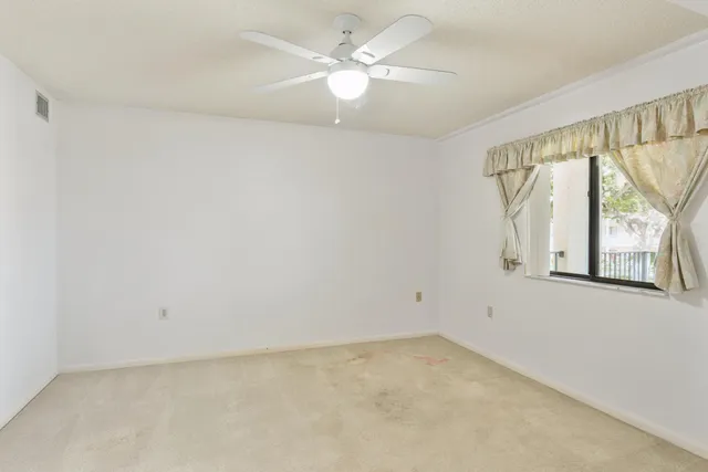 an aerial view of a house with a garden and lake view