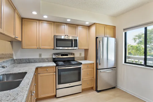 a view of a livingroom with a ceiling fan and window