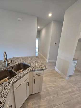 a bathroom with a granite countertop sink a toilet and shower