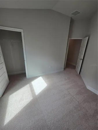 a spacious bedroom with a bed and a couch