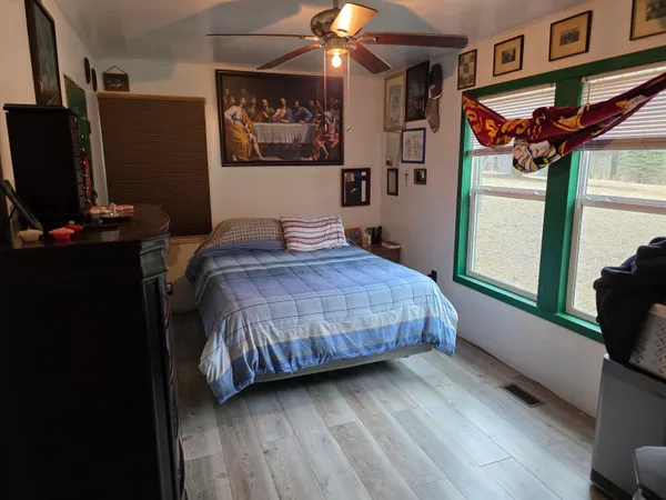 a bedroom with a bed and a flat screen tv
