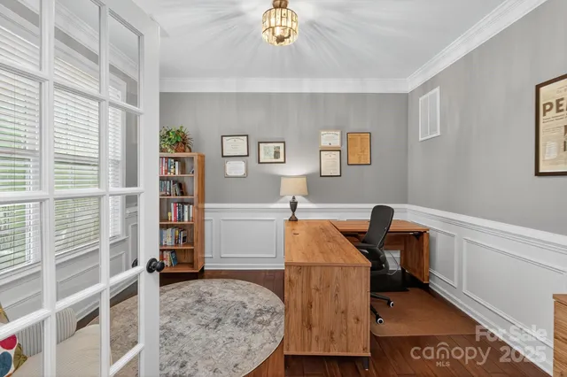 a kitchen with a sink cabinets and wooden floor