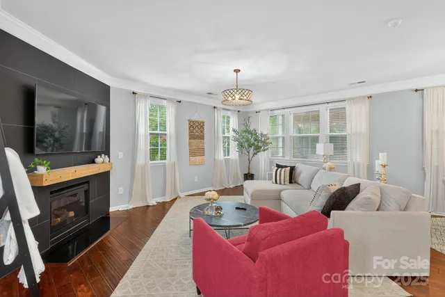 a kitchen with stainless steel appliances granite countertop a kitchen island a stove and a wooden floors