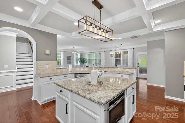 a bedroom with a bed and furniture with a flat tv screen