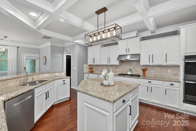 a spacious bathroom with a double vanity sink a mirror and a