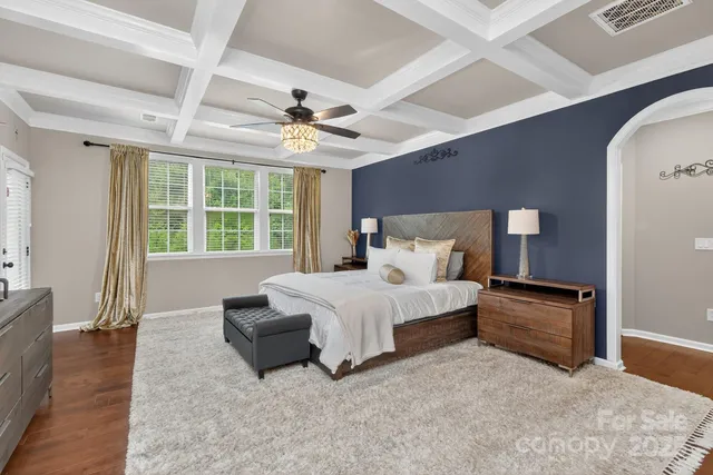 a view of a hallway with a dining table & chairs
