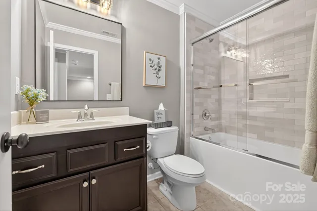 a view of a bedroom with baby crib and furniture