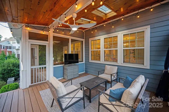 a backyard of a house with a garden and outdoor seating