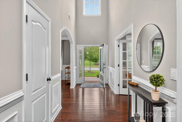 a living room with furniture a flat screen tv and kitchen view