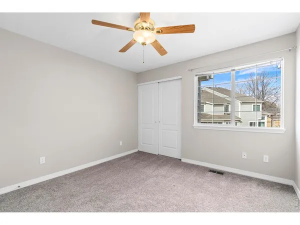 a bathroom with a granite countertop sink a toilet and a large mirror