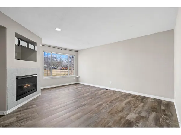 a view of an empty room and fire place