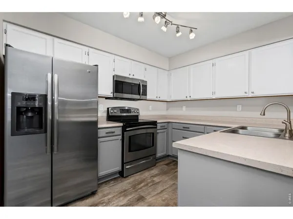 a kitchen with a sink cabinets and window
