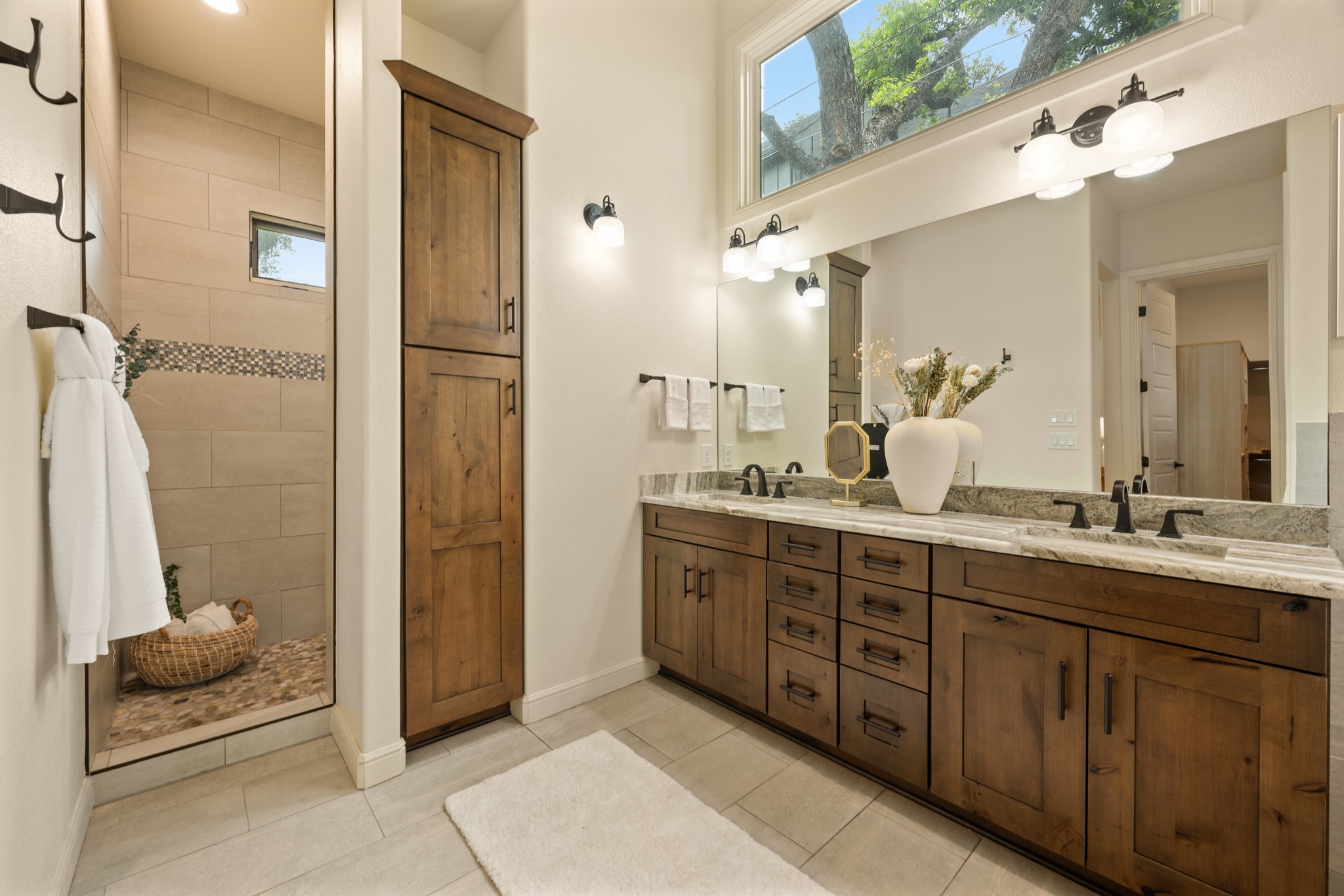 3907 Bailey Lane Austin, TX 78756 - Photo 18 of 40 No expense was spared in the luxurious ensuite bath that features a gorgeous dual vanity, free-standing soaking tub, and a walk-in shower with a rainfall shower head and a wall mount shower head