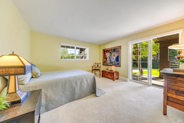 a bed room with a bed and a chair