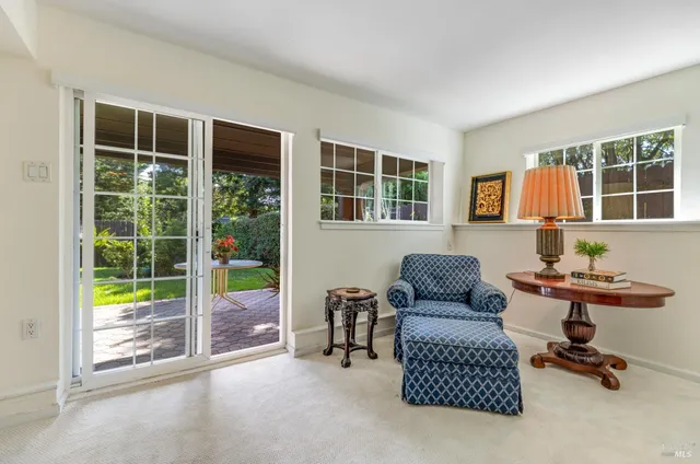 a livingroom with workspace and a window