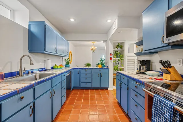 a kitchen with stainless steel appliances granite countertop a sink and cabinets