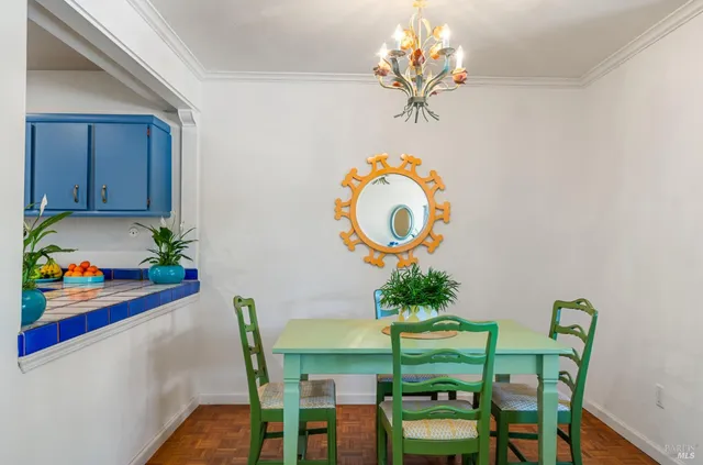 a dining room filled with furniture and chandelier