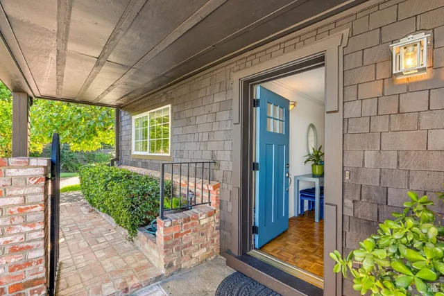 a house with potted plants in front of it