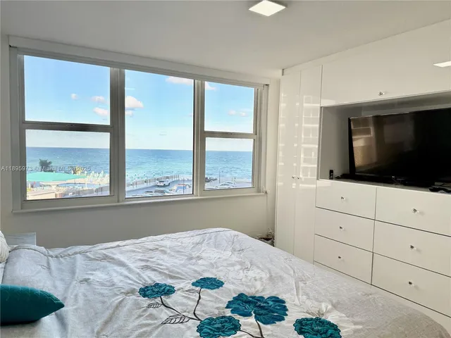 a bed room with a bed and a large window