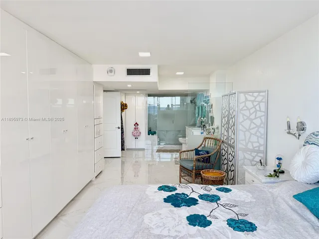 a living room with furniture a large window and a chandelier