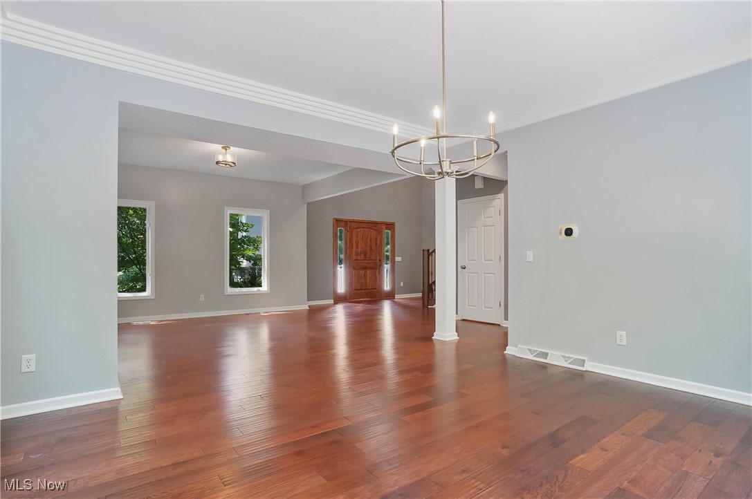 1453 Prospect Road Hudson, OH 44236 - Photo 7 of 50 Spare room featuring a chandelier, wood finished floors, and ornamental molding