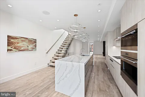 a view of a kitchen with a sink stainless steel appliances and cabinets