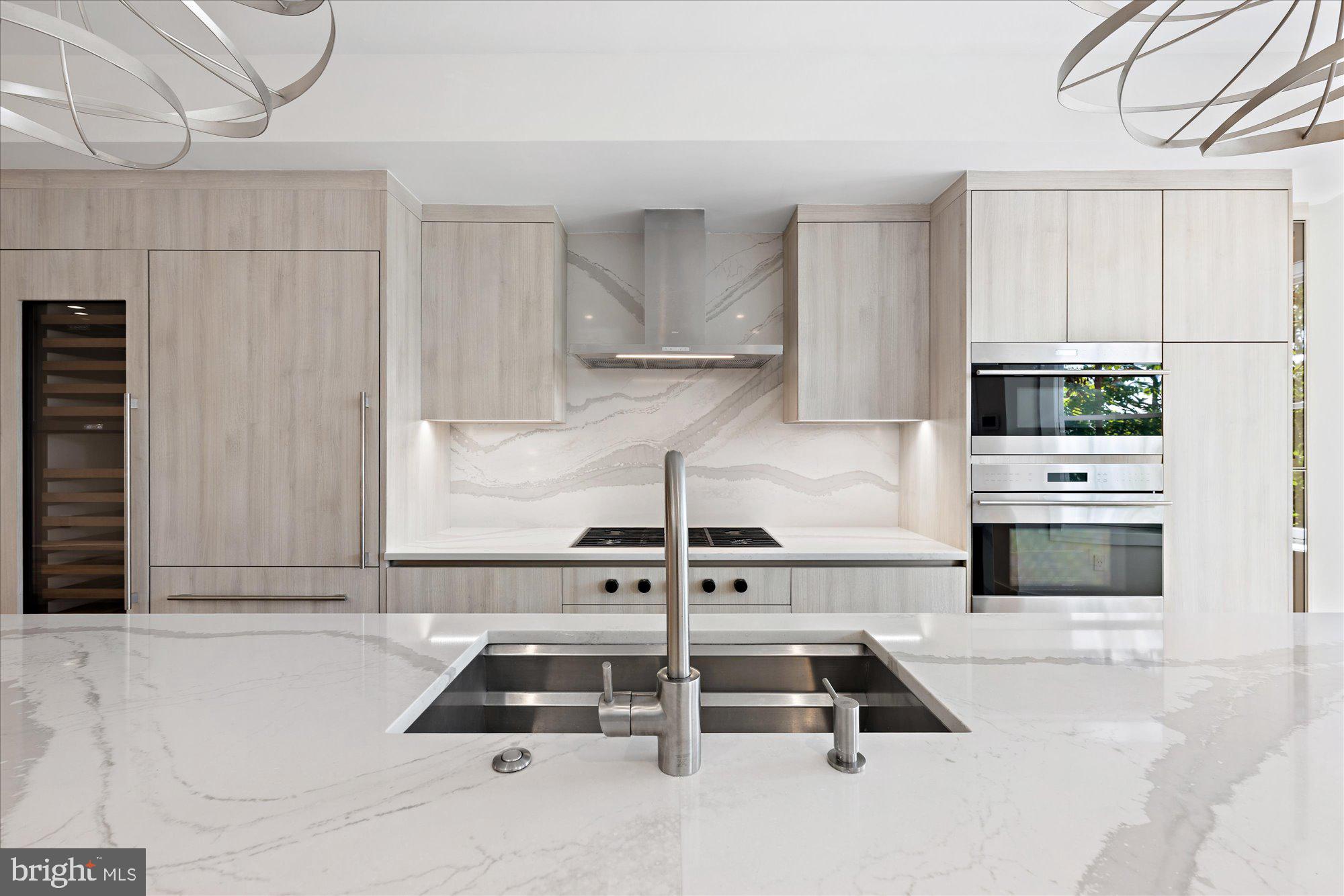 1777 T Street Northwest, Unit 5 Washington, DC 20009 - Photo 15 of 48 a kitchen with kitchen island a stove and a refrigerator with white cabinets