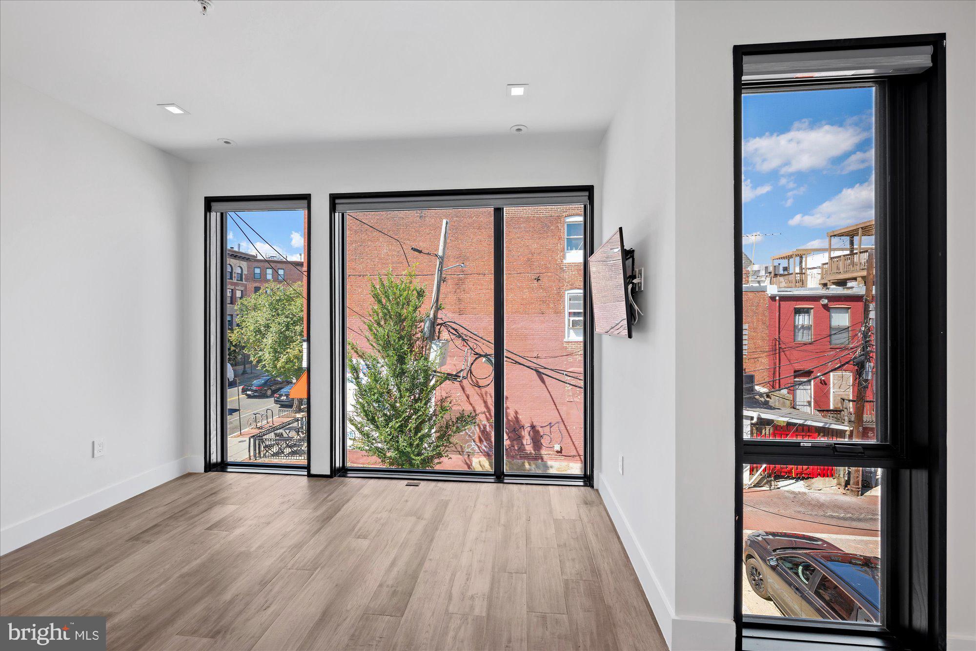 1777 T Street Northwest, Unit 5 Washington, DC 20009 - Photo 25 of 48 an empty room with wooden floor and windows