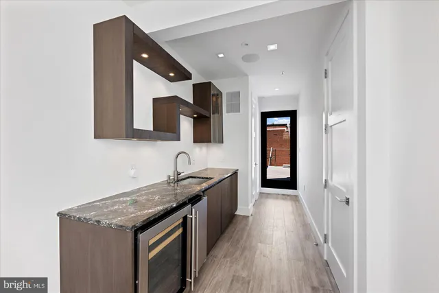 a kitchen with a sink and a refrigerator