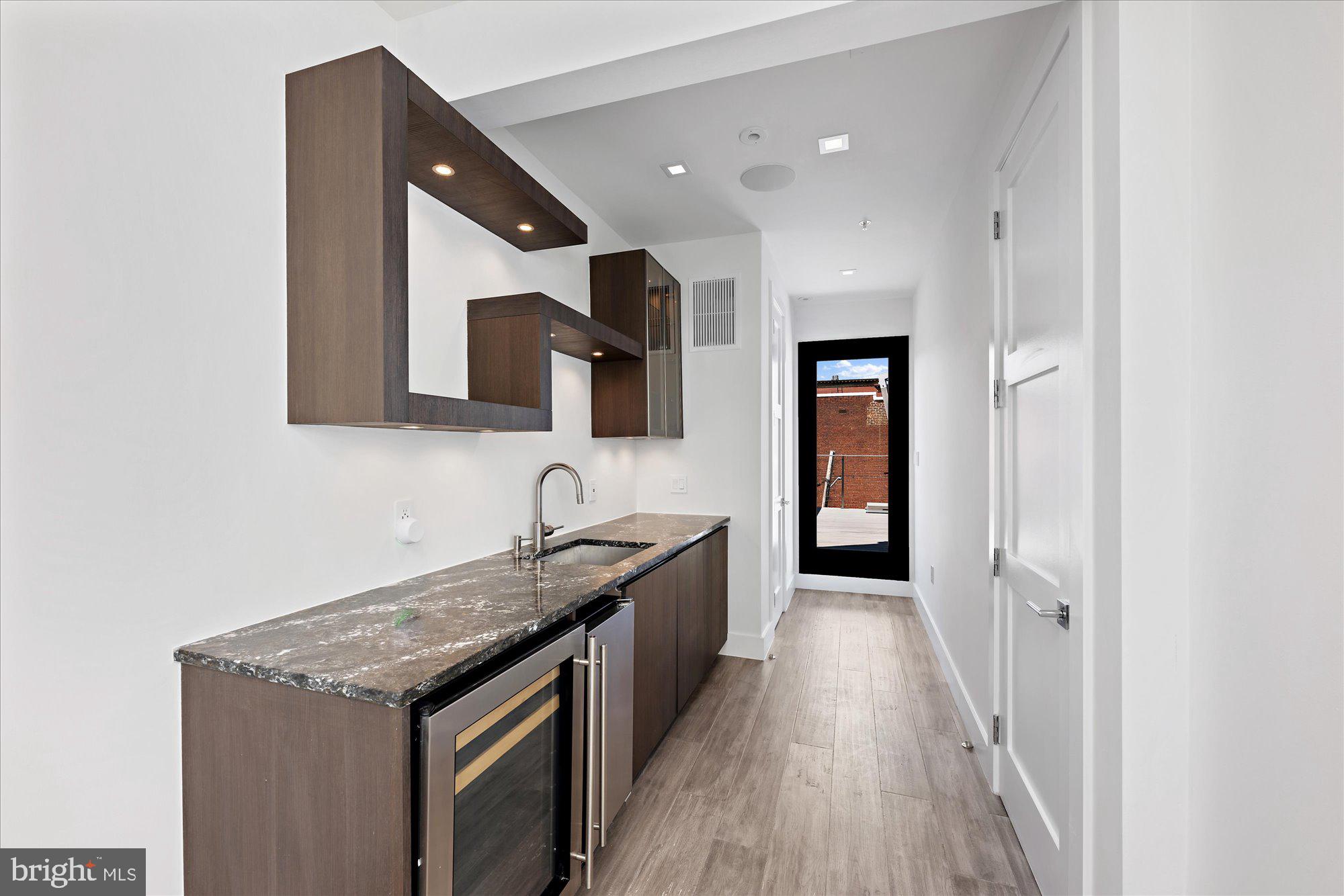 1777 T Street Northwest, Unit 5 Washington, DC 20009 - Photo 30 of 48 a kitchen with a sink and a refrigerator
