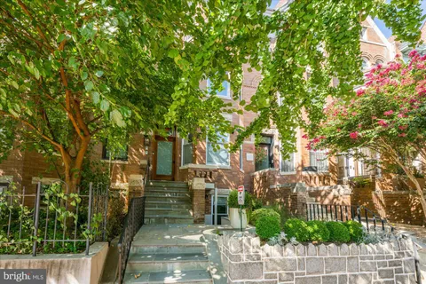 a view of a patio with table and chairs and potted plants