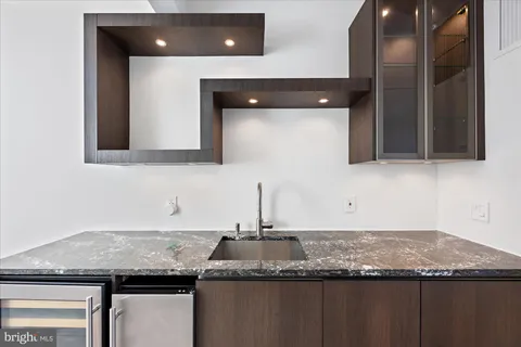 a kitchen with granite countertop a sink and cabinets
